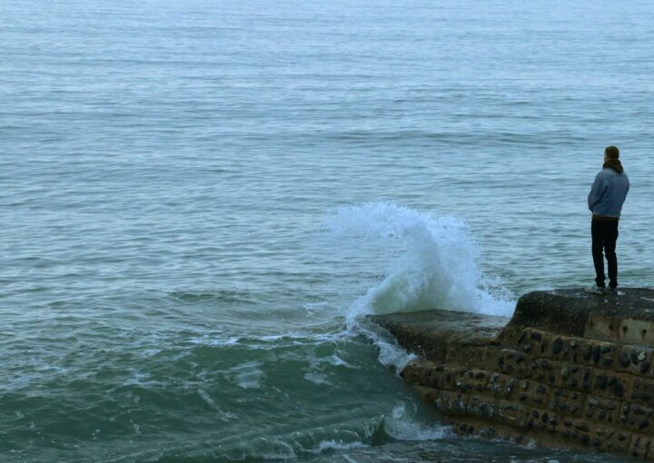 brown rock formation on sea during daytime