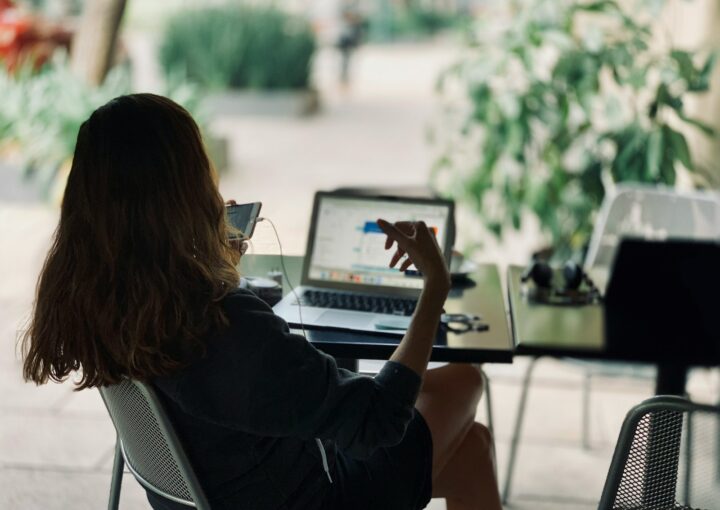 woman sitting on chair in front of table with laptop