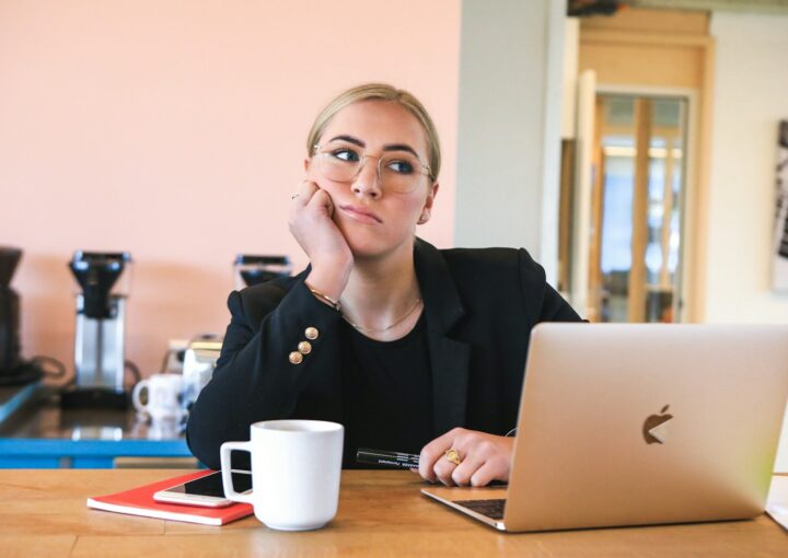 woman in black long sleeve shirt using macbook