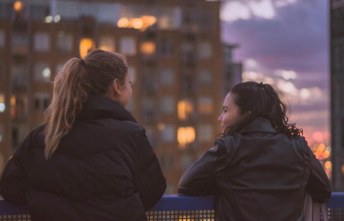 two women standing near railings