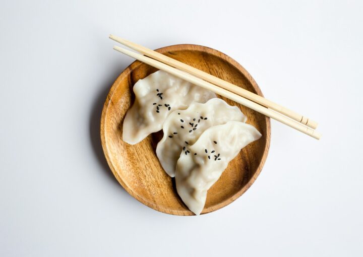 three white dimsum on brown bowl