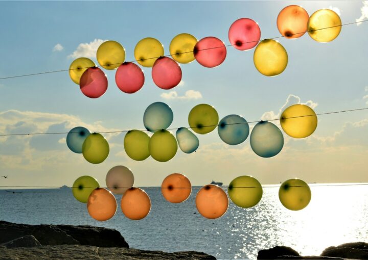 blue, yellow, and red balloons tied on string