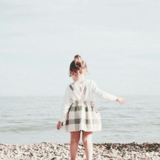 girl walking towards the sea