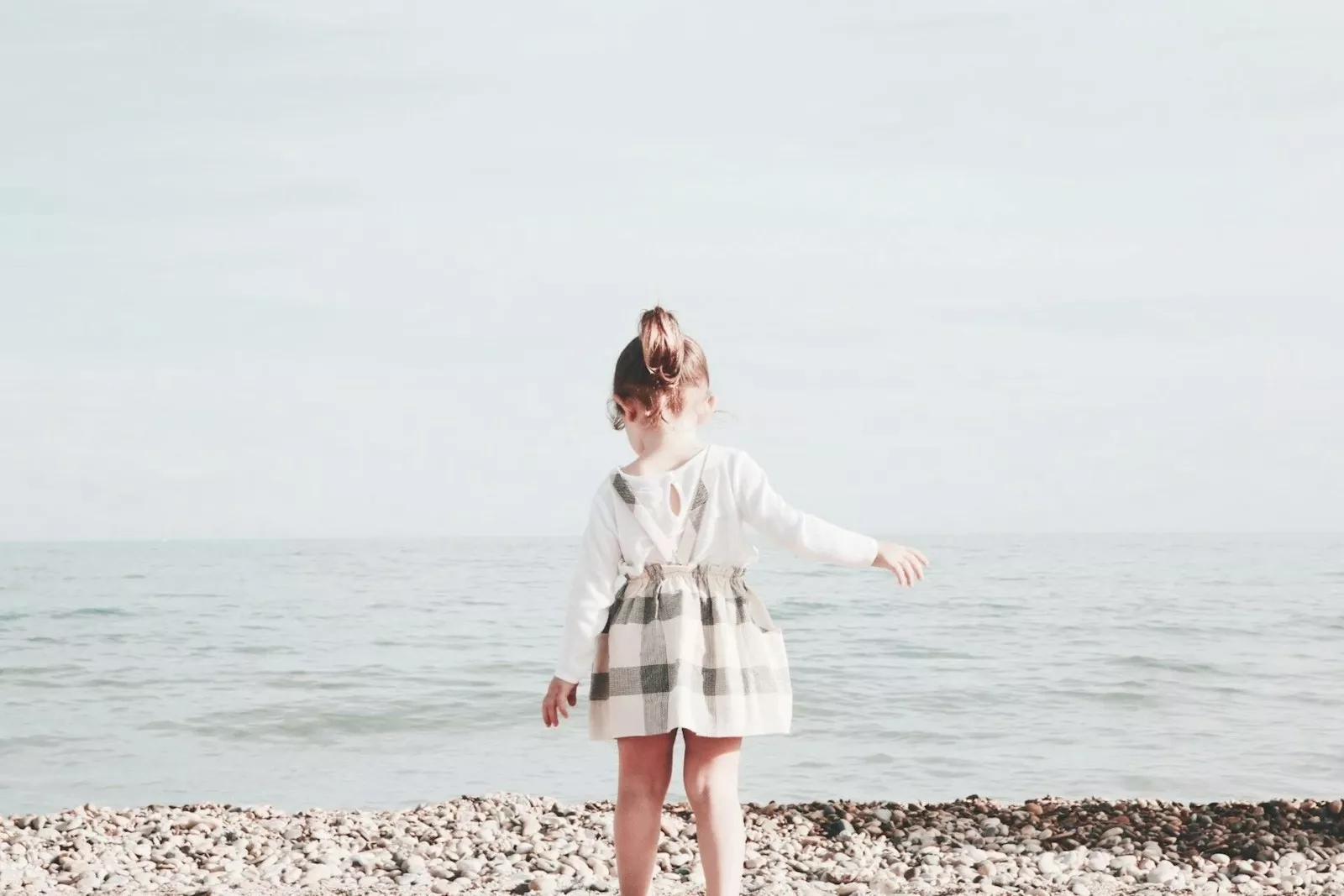girl walking towards the sea