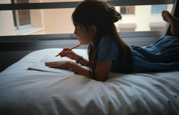 a woman writing on a book