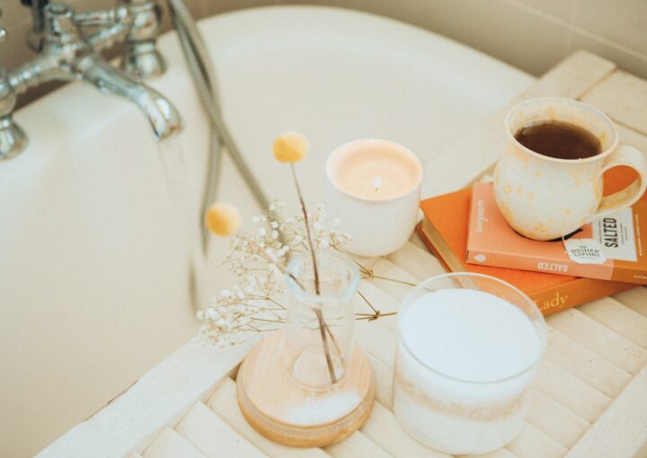 a cup of coffee and some books on a bathtub