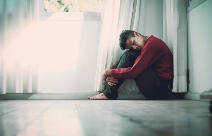 man beside white frame window