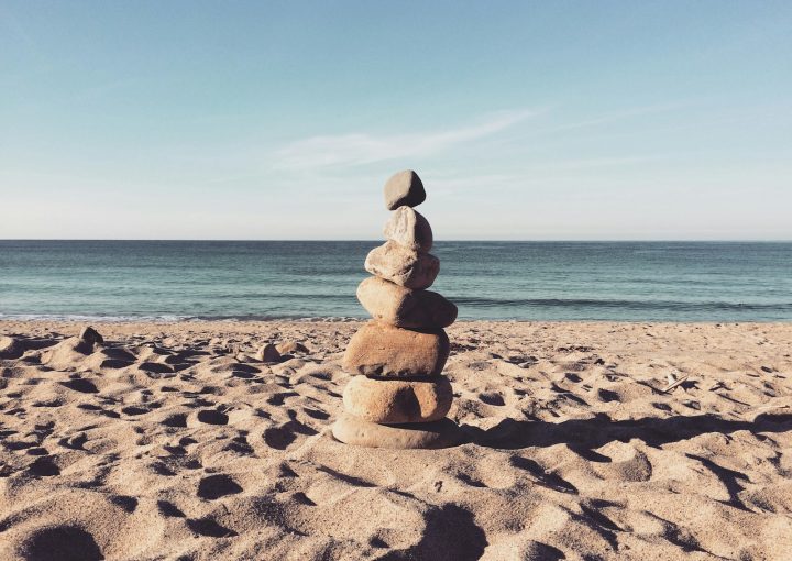 stacked stones on the sea shore during daytime