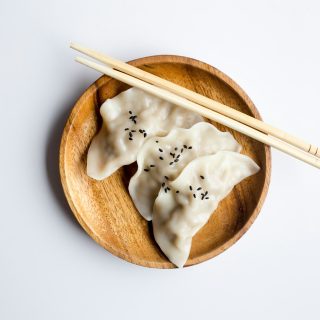 three white dimsum on brown bowl