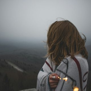 woman covered with white blanket