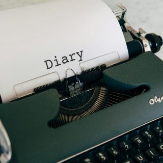 a close up of a typewriter with a paper on it