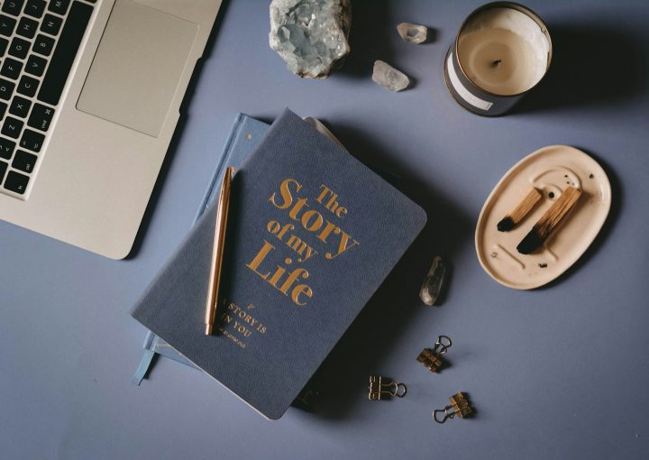 a book sitting on top of a table next to a laptop