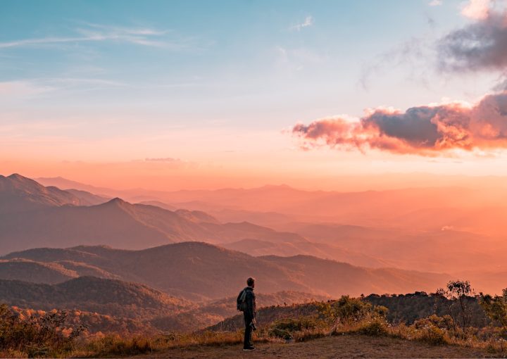 man standing on hill digital wallpaper