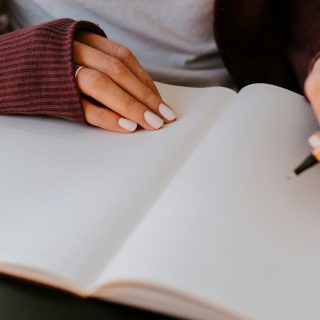 person writing on white paper