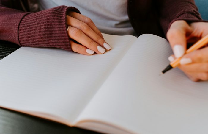 person writing on white paper