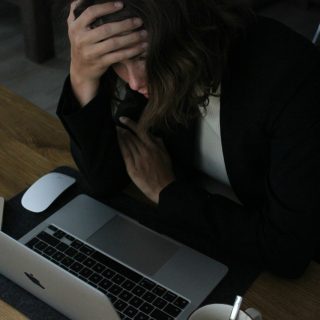 woman in black blazer sitting on chair