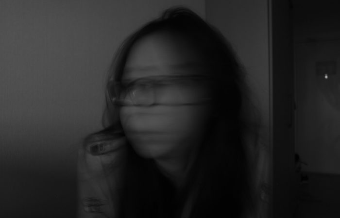 a blurry photo of a woman with glasses