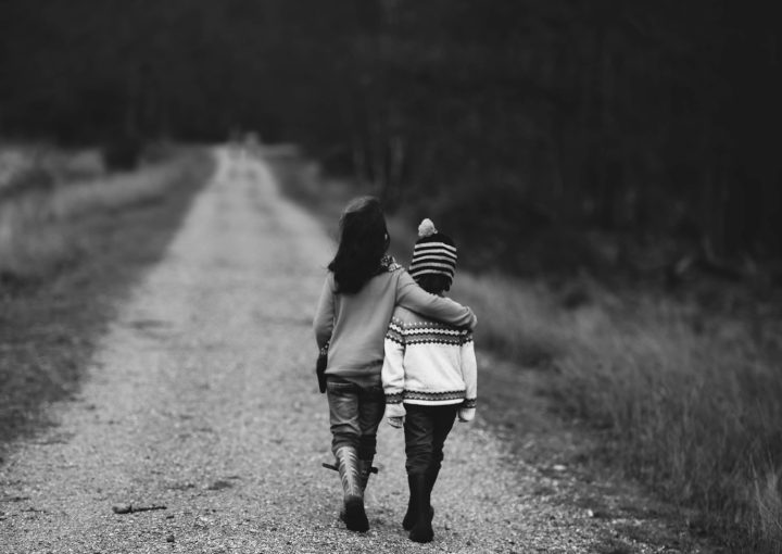 grayscale photography of kids walking on road