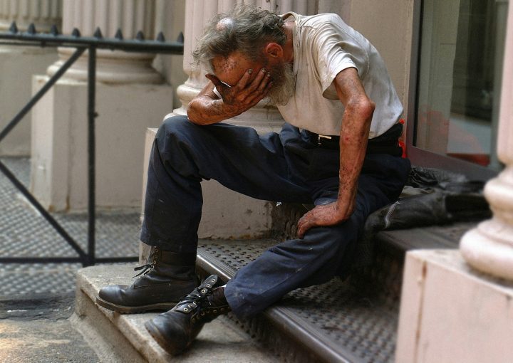 a man sitting on a step with his head in his hands