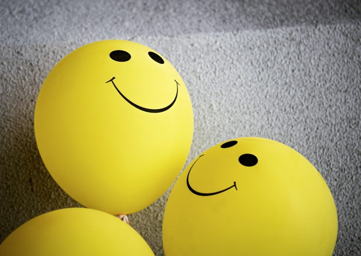 yellow smiley emoji on gray textile
