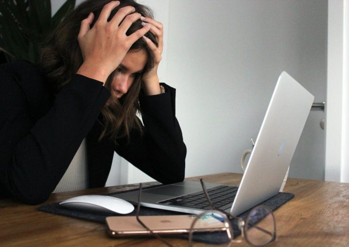 a woman sitting in front of a laptop computer