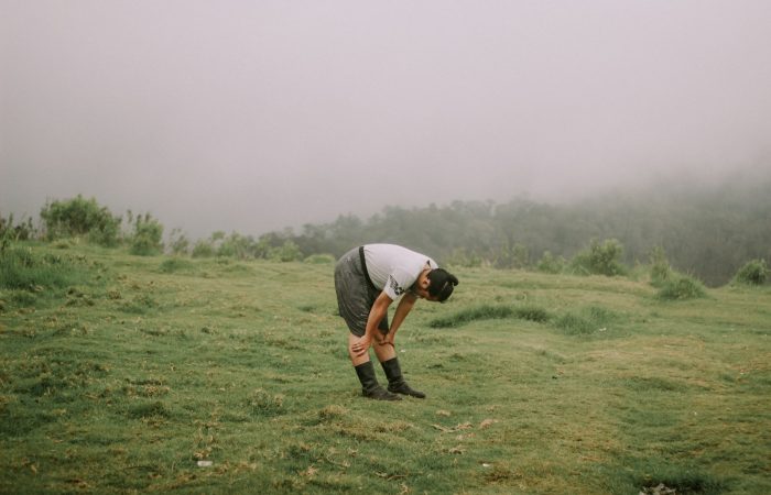 man in gray t-shirt and black shorts playing golf during daytime